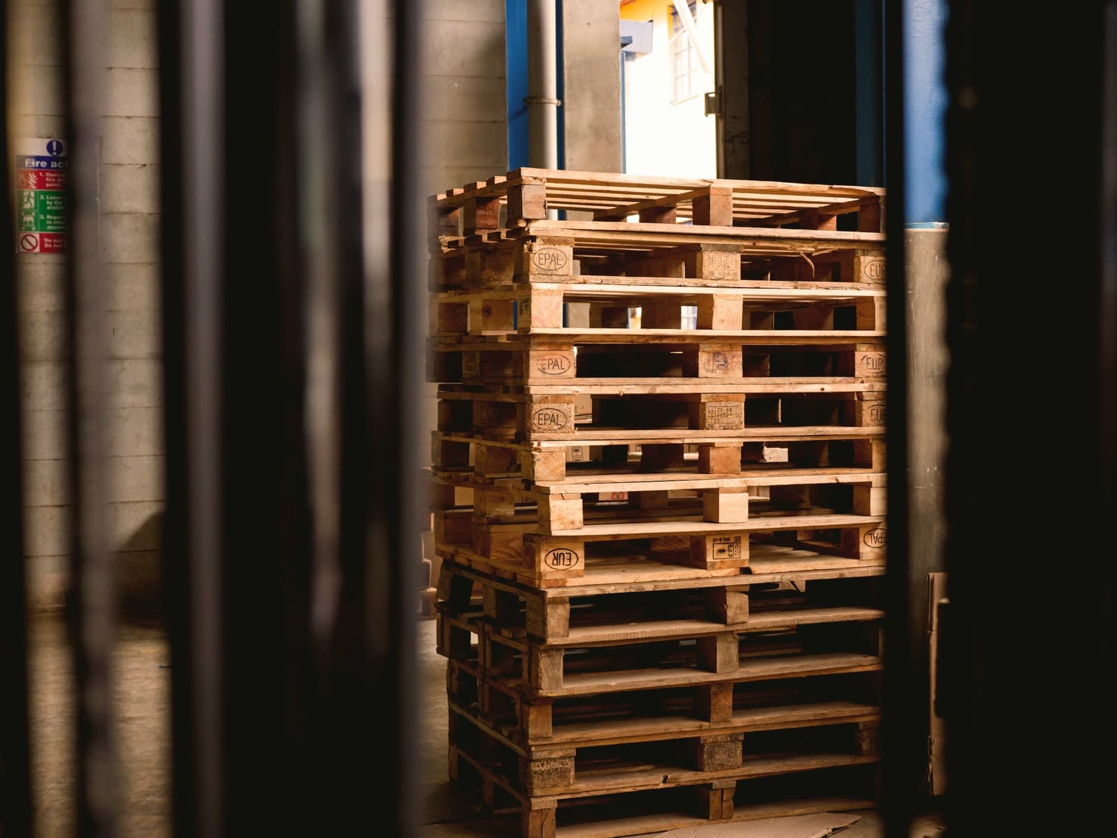Pallet manufacturing facility with saw lines and stacked pallets