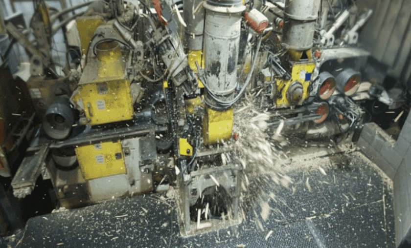 Industrial planer mill interior showing high-speed planer machinery and dust collection systems at a Sierra Pacific Industries facility